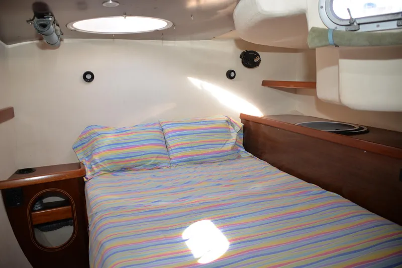 Dreamweaver Yacht Photos Pics Cozy cabin interior of 2004 Fountaine Pajot Belize 43 with striped bedding.