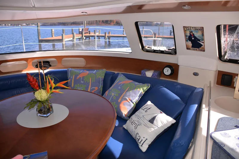 Dreamweaver Yacht Photos Pics Interior of 2004 Fountaine Pajot Belize 43 yacht with blue seating and decorative pillows.