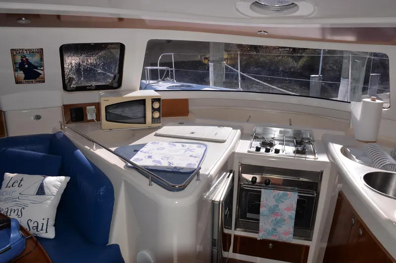 Dreamweaver Yacht Photos Pics Interior of 2004 Fountaine Pajot Belize 43 catamaran with kitchen and seating area.