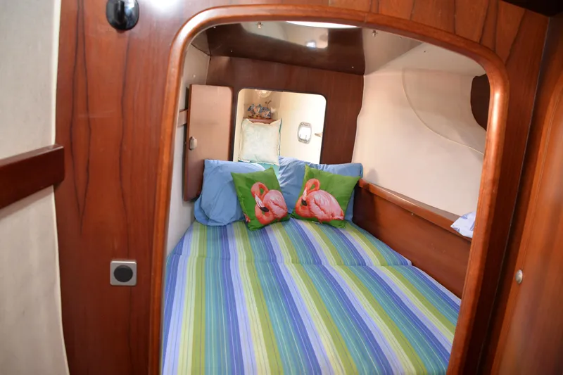 Dreamweaver Yacht Photos Pics Cozy cabin interior of 2004 Fountaine Pajot Belize 43 with colorful bedding.