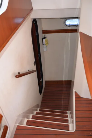 Dreamweaver Yacht Photos Pics Staircase inside 2004 Fountaine Pajot Belize 43 catamaran with wooden steps and handrail.