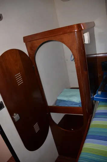Dreamweaver Yacht Photos Pics Wooden cabinet in 2004 Fountaine Pajot Belize 43 yacht interior, with folded linens.