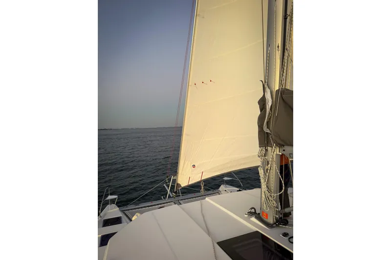 Panthera Yacht Photos Pics Sailing on a 2021 Leopard 42 catamaran with white sails against a clear sky.