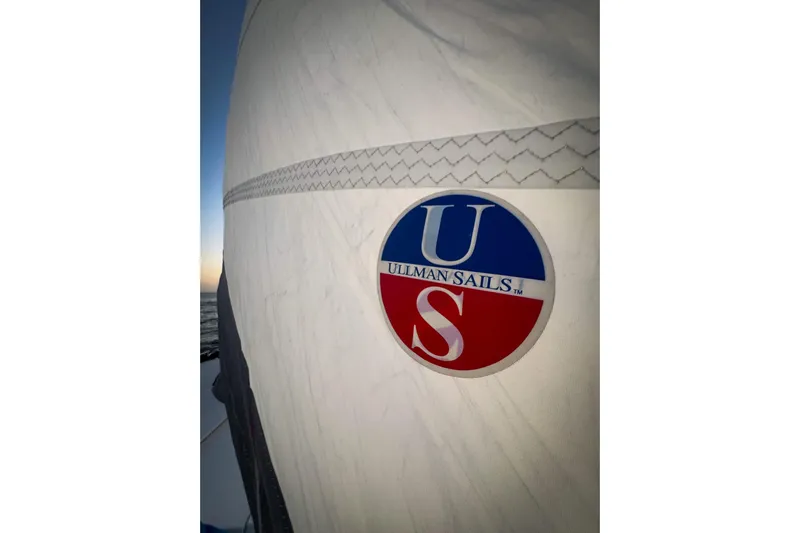 Panthera Yacht Photos Pics Sailboat with Ullman Sails logo, Leopard 42 model, 2021, at sunset on the ocean.