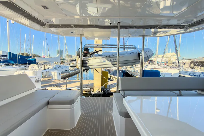 Panthera Yacht Photos Pics Leopard 42 yacht interior with marina view, featuring seating and a dinghy, 2021 model.