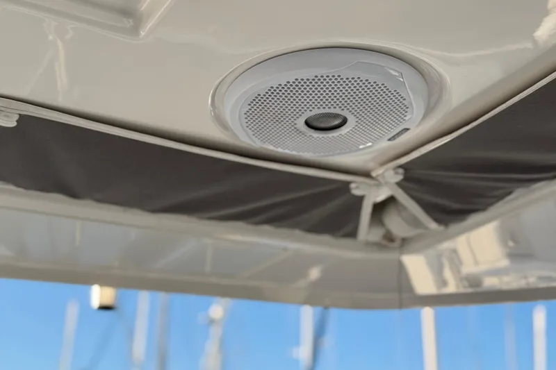 Panthera Yacht Photos Pics Ceiling speaker on 2021 Leopard 42 yacht, with sunshade and marina background.
