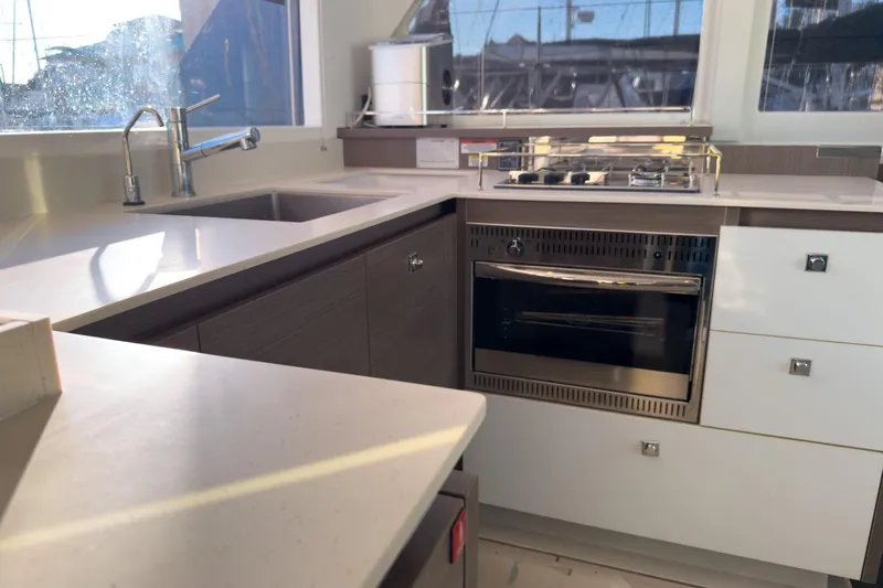 Panthera Yacht Photos Pics Modern kitchen in a 2021 Leopard 42 yacht with sleek countertops and stainless steel appliances.