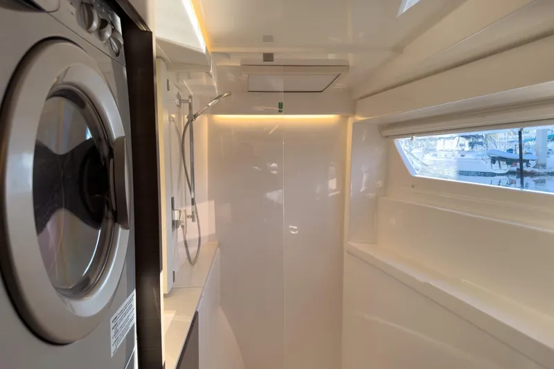 Panthera Yacht Photos Pics Modern bathroom with washer in 2021 Leopard 42 yacht, featuring sleek design and window view.