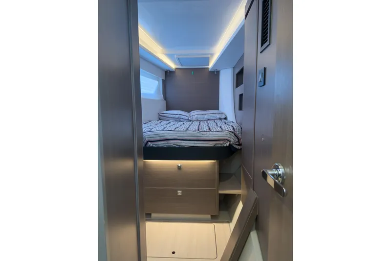 Panthera Yacht Photos Pics Modern cabin interior of 2021 Leopard 42 yacht with cozy bed and sleek design.