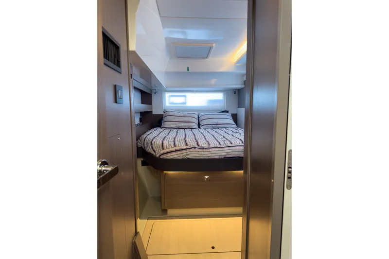 Panthera Yacht Photos Pics Cozy bedroom interior of 2021 Leopard 42 yacht with striped bedding.
