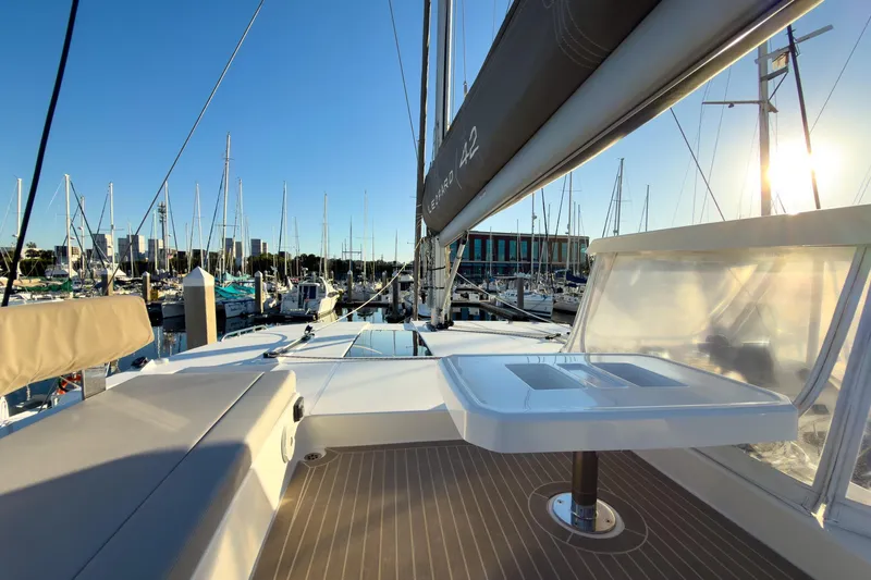 Panthera Yacht Photos Pics 2021 Leopard 42 catamaran deck view at marina, with clear sky and sunlight.