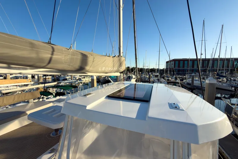 Panthera Yacht Photos Pics 2021 Leopard 42 catamaran docked at marina under clear blue sky.