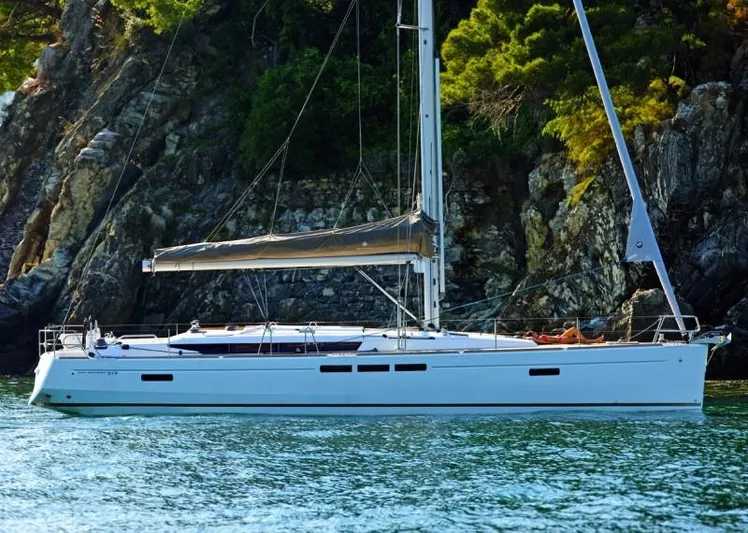 Fortuna Yacht Photos Pics Manufacturer Provided Image: 2016 Jeanneau Sun Odyssey 519 sailboat anchored near rocky shoreline.