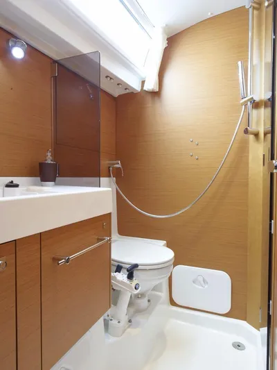 Fortuna Yacht Photos Pics Manufacturer Provided Image: Modern bathroom in 2016 Jeanneau Sun Odyssey 519 sailboat with wooden cabinetry.