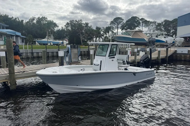 Your Next Boat! Yacht Photos Pics 2026 Blackfin 262 HB boat docked at marina with overcast sky.