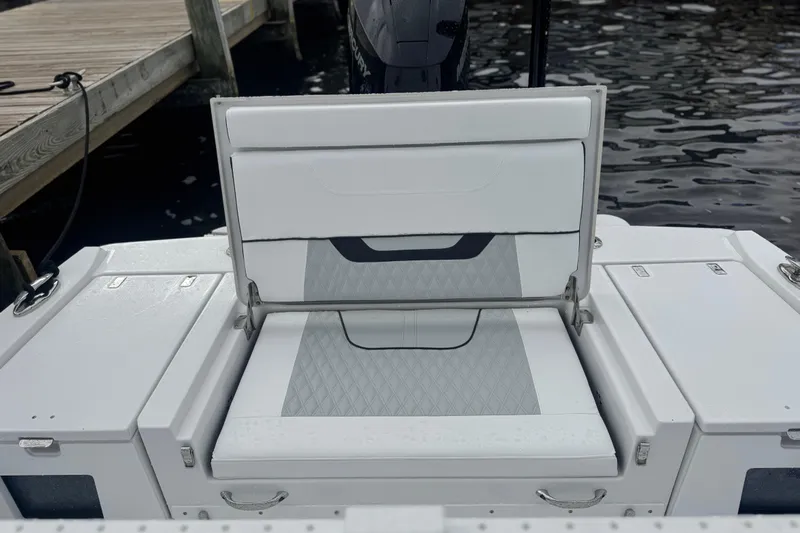 Your Next Boat! Yacht Photos Pics 2026 Blackfin 262 HB boat seat with diamond-pattern upholstery near dock.