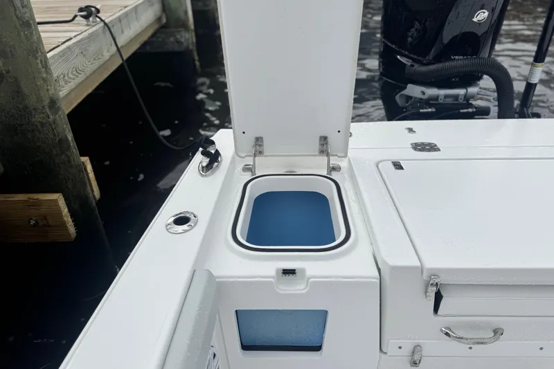Your Next Boat! Yacht Photos Pics Open storage compartment on 2026 Blackfin 262 HB boat, docked by the water.