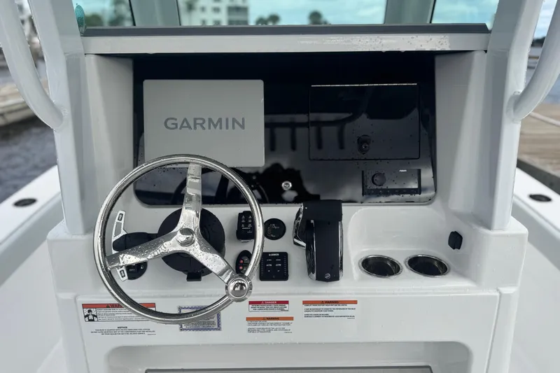 Your Next Boat! Yacht Photos Pics 2026 Blackfin 262 HB boat dashboard with Garmin navigation system and steering wheel.