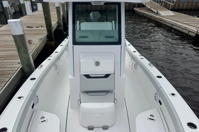 Your Next Boat! Yacht Photos Pics 2026 Blackfin 262 HB boat docked, showcasing sleek design and spacious deck.