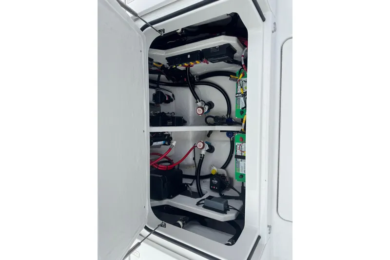 Your Next Boat! Yacht Photos Pics Electrical compartment of 2026 Blackfin 262 HB boat, showcasing wiring and battery setup.