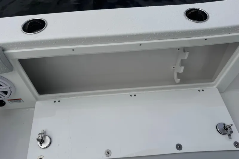 Your Next Boat! Yacht Photos Pics Storage compartment on a 2026 Blackfin 262 HB boat, featuring rod holders and secure latches.