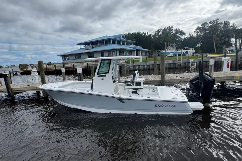 Your Next Boat! Yacht Photos Pics 2026 Blackfin 262 HB boat docked at a marina under cloudy skies.