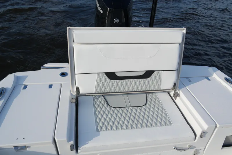 Your Next Boat! Yacht Photos Pics 2026 Blackfin 262 HB boat with open storage compartment, white cushioned seating, and diamond pattern design.