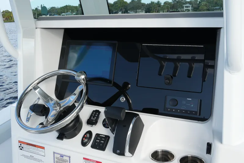 Your Next Boat! Yacht Photos Pics 2026 Blackfin 262 HB boat dashboard with steering wheel and control panel.
