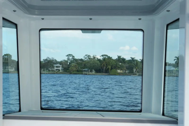 Your Next Boat! Yacht Photos Pics View from inside a 2026 Blackfin 262 HB boat, overlooking a serene waterfront scene.