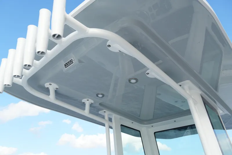 Your Next Boat! Yacht Photos Pics 2026 Blackfin 262 HB boat roof with rod holders against blue sky.