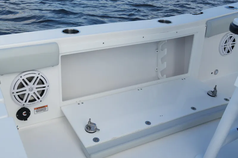 Your Next Boat! Yacht Photos Pics 2026 Blackfin 262 HB boat interior with storage compartment and speaker, on water.