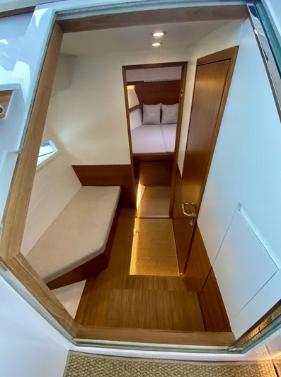  Yacht Photos Pics Interior of 2023 Delta Powerboats 33 Coupe, featuring cozy wooden cabin and seating area.