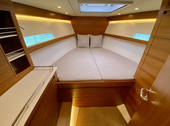  Yacht Photos Pics 2023 Delta Powerboats 33 Coupe cabin with cozy bed and modern wood interior design.