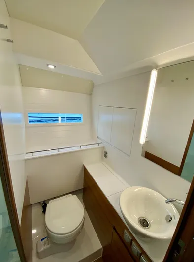  Yacht Photos Pics Modern bathroom in 2023 Delta Powerboats 33 Coupe, featuring sleek design and compact fixtures.
