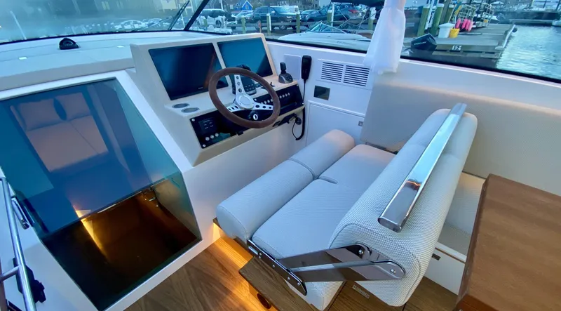  Yacht Photos Pics 2023 Delta Powerboats 33 Coupe interior with modern helm and comfortable seating.