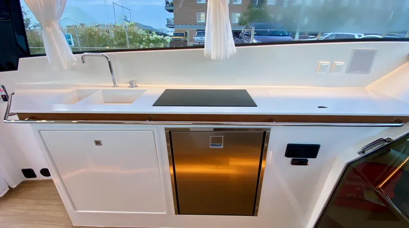  Yacht Photos Pics Modern kitchen area in 2023 Delta Powerboats 33 Coupe with sink and stove.