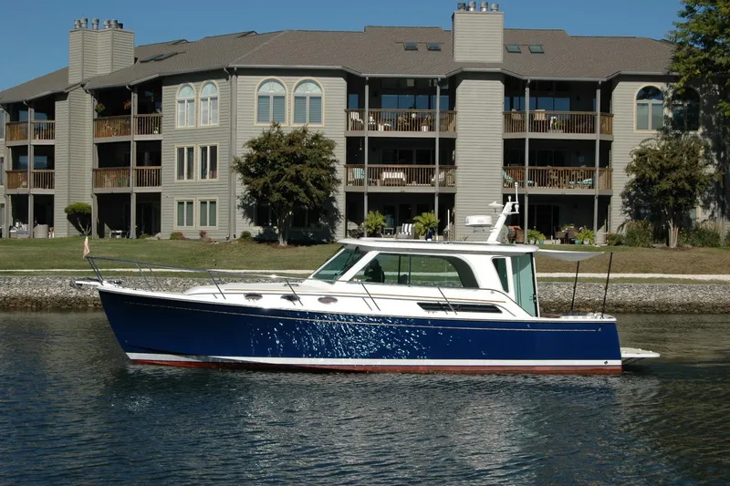 Bonnie Blue Yacht Photos Pics 2015 Back Cove 37 boat on water near waterfront apartments.