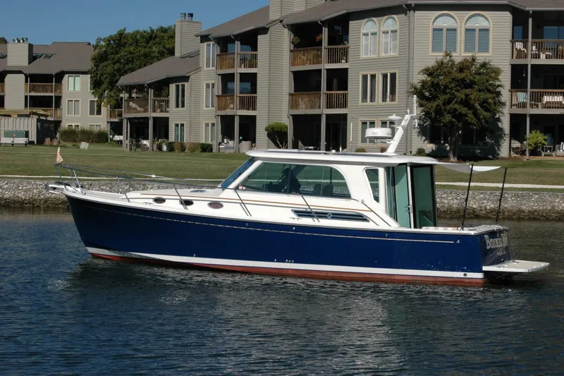 Bonnie Blue Yacht Photos Pics 2015 Back Cove 37 boat on water near residential buildings.