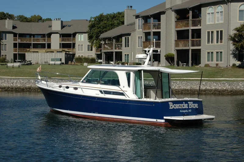Bonnie Blue Yacht Photos Pics 2015 Back Cove 37 boat on water near residential buildings.