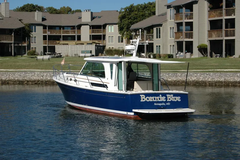 Bonnie Blue Yacht Photos Pics 2015 Back Cove 37 boat "Bonnie Blue" on water near residential buildings.
