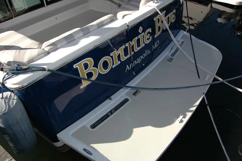 Bonnie Blue Yacht Photos Pics 2015 Back Cove 37 boat stern with name and location, docked in water.