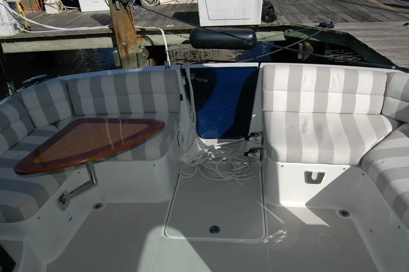 Bonnie Blue Yacht Photos Pics 2015 Back Cove 37 boat interior with striped seating and wooden table.