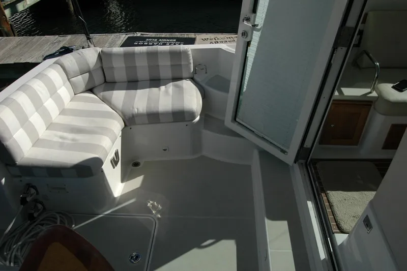 Bonnie Blue Yacht Photos Pics 2015 Back Cove 37 boat interior with striped seating and open door to cabin.