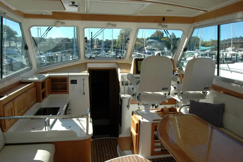 Bonnie Blue Yacht Photos Pics Interior of 2015 Back Cove 37 yacht with helm, seating, and kitchen area.