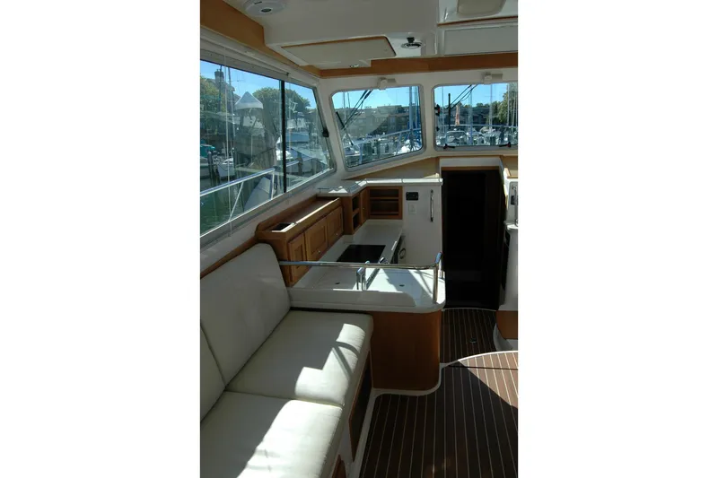 Bonnie Blue Yacht Photos Pics Interior of 2015 Back Cove 37 yacht with seating and windows overlooking marina.