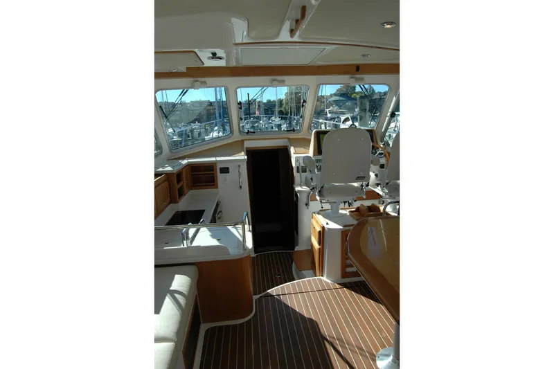 Bonnie Blue Yacht Photos Pics Interior of 2015 Back Cove 37 yacht with helm, seating, and wooden flooring.