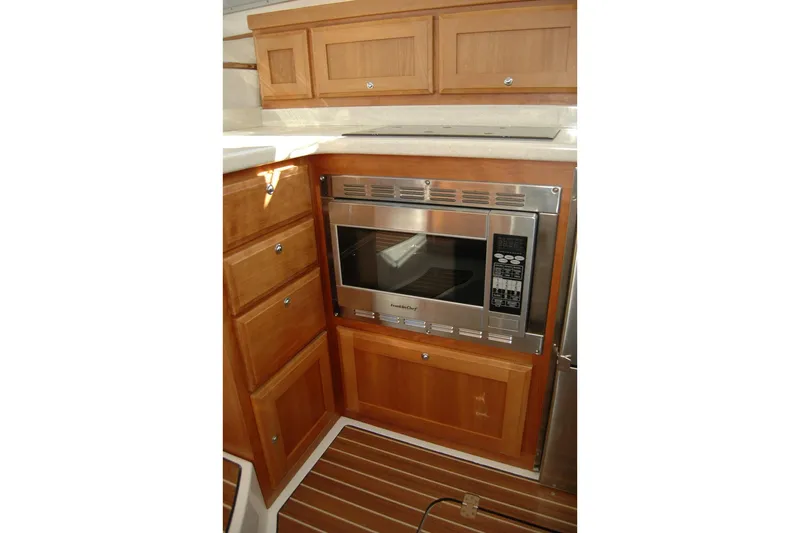 Bonnie Blue Yacht Photos Pics Galley kitchen in 2015 Back Cove 37 yacht with microwave and wooden cabinetry.