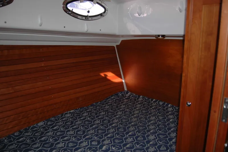 Bonnie Blue Yacht Photos Pics 2015 Back Cove 37 cabin interior with wood paneling and patterned bedding.