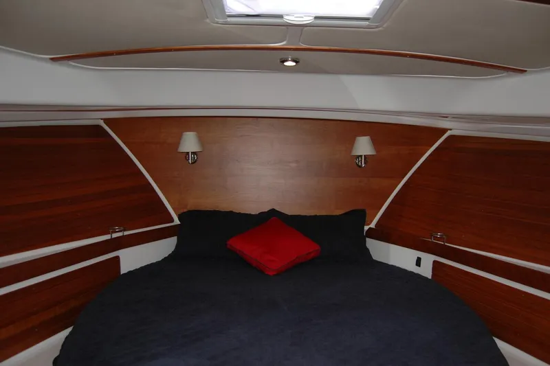 Bonnie Blue Yacht Photos Pics Luxurious cabin interior of 2015 Back Cove 37 yacht with wood paneling and cozy bedding.