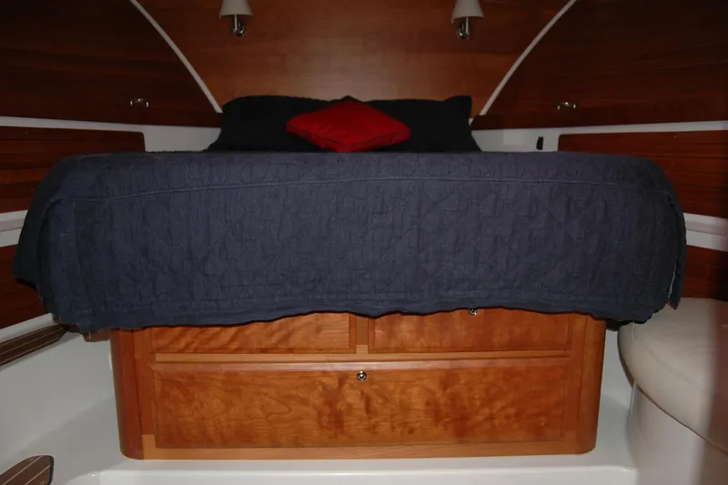 Bonnie Blue Yacht Photos Pics 2015 Back Cove 37 cabin interior with wooden storage and cozy bedding.